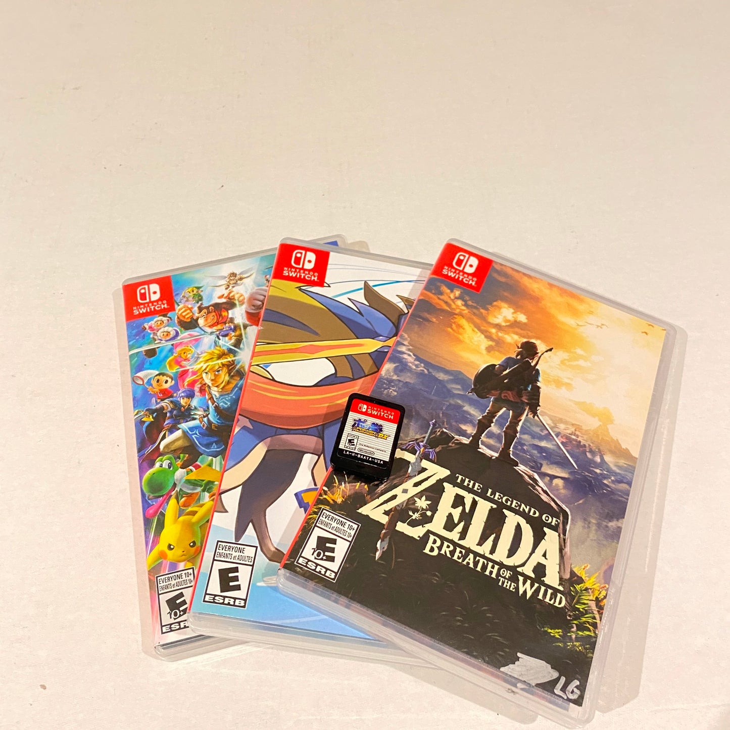 Lot of 4 Switch Games - Super Smash, Zelda, Pokemon Sword, Pokemon Tournament